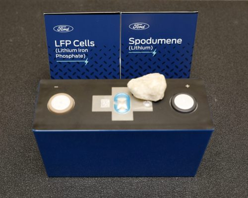 A lithium iron phosphate (LFP) battery and spodumene, a source of lithium. at Ford Ion Park in Romulus, Mich., on Monday, Feb. 13, 2023.